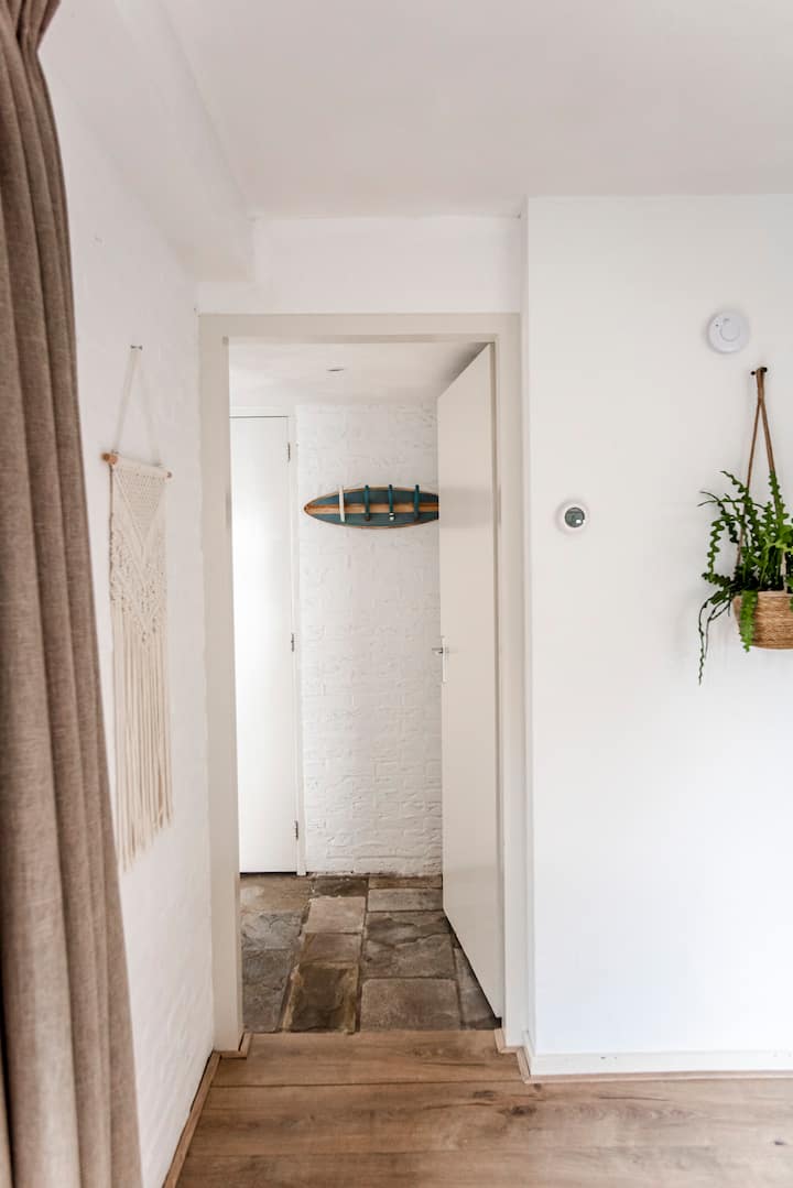 Hallway with surfboard hooks