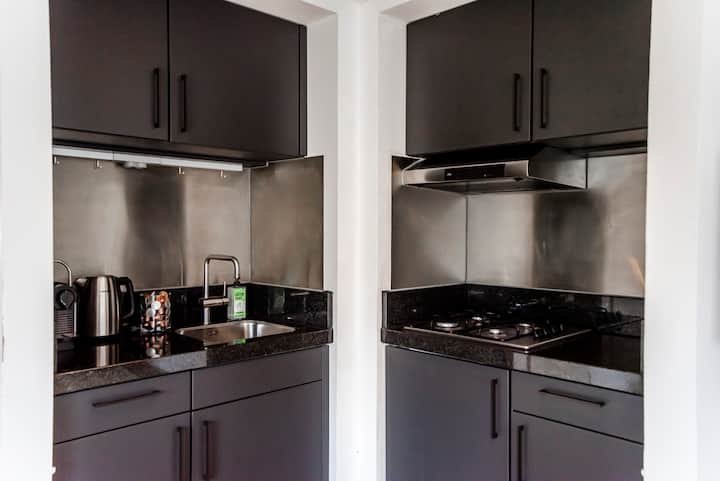 Modern dark kitchen with stainless steel